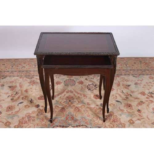 32 - A CONTINENTAL KINGWOOD AND GILT BRASS MOUNTED NEST OF TWO TABLES each of rectangular outline with br... 