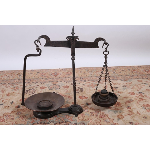 34 - A CAST IRON AND COPPER WEIGHING SCALES with weights 62cm (h) x 66cm (w) x 30cm (d)