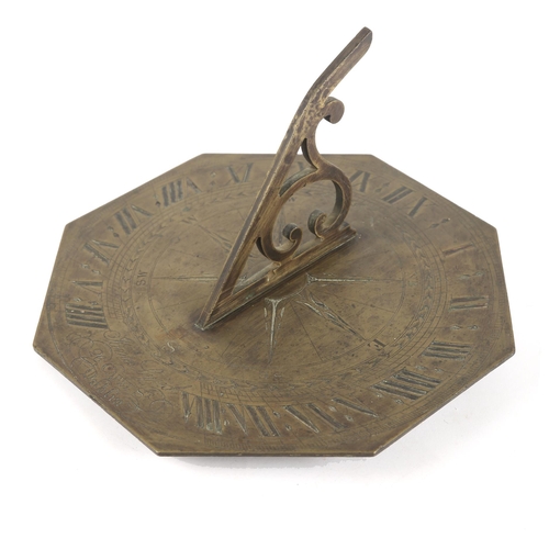 26 - An early 19th century brass octagonal sundial, the scrolled gnomon centred on a finely engraved comp... 
