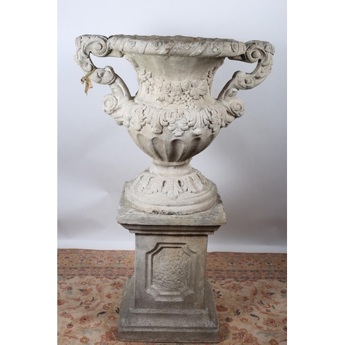 1 - A COMPOSITION URN of semi-lobed Campana form moulded in high relief with fruiting vines and foliage ... 