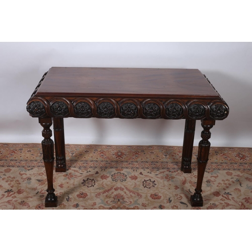 11 - A 19TH CENTURY MAHOGANY CONSOLE TABLE of rectangular outline with flowerhead and foliate carved frie... 