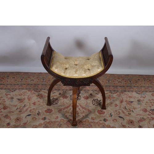 12 - A 19TH CENTURY CARVED MAHOGANY STOOL the U-shaped button upholstered seat with carved apron on shape... 