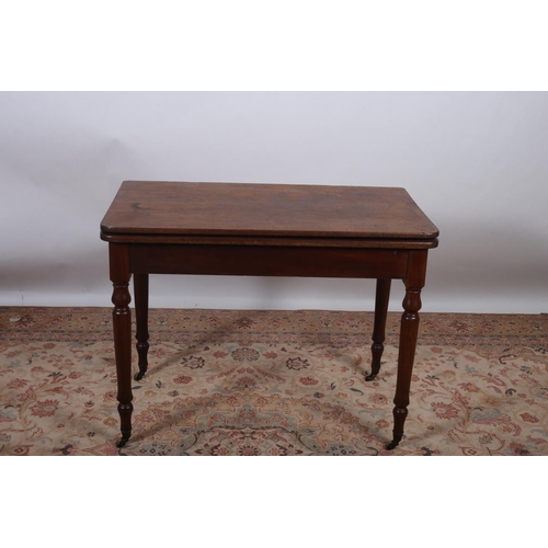 18 - A 19TH CENTURY MAHOGANY FOLD OVER SUPPER TABLE the rectangular hinged top above a plain apron on bal... 
