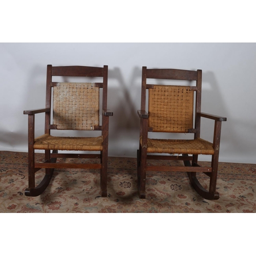 2 - A PAIR OF HARDWOOD ROCKING CHAIRS each of typical form with woven back and seat on moulded base