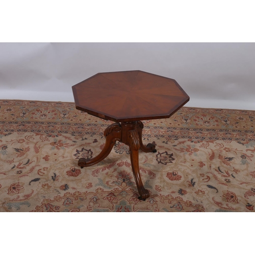 22 - A 19TH CENTURY STAINWOOD AND ROSEWOOD CROSS BANDED WINE TABLE of octagonal outline the shaped top ab... 