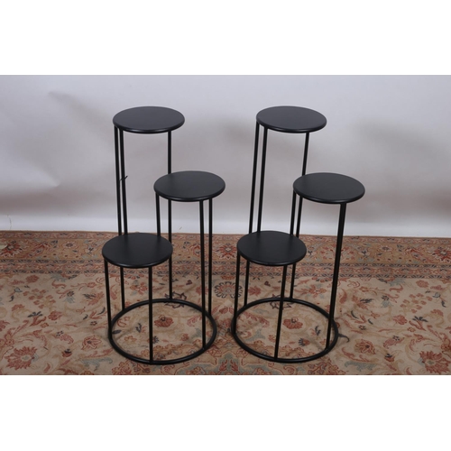27 - A PAIR OF BLACK METAL MULTIFLORA PLANTERS each with a circular dish raised on tubular supports 80cm ... 