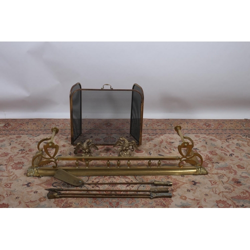 29 - A 19TH CENTURY BRASS FENDER 26cm (h) x 139cm (w) x 39cm (d) together with three brass fire irons mes... 