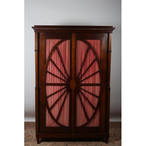 35 - A VINTAGE MAHOGANY WARDROBE the roped cornice above a pair of astragal glazed doors with curtains co... 
