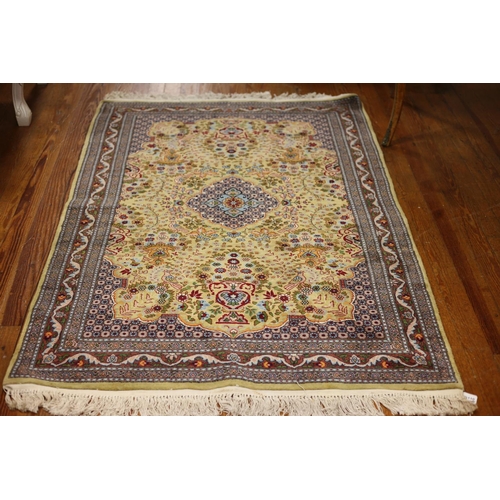 54 - A CASHMERE WOOL RUG the light yellow and blue ground with central panel filled with stylized flowerh... 