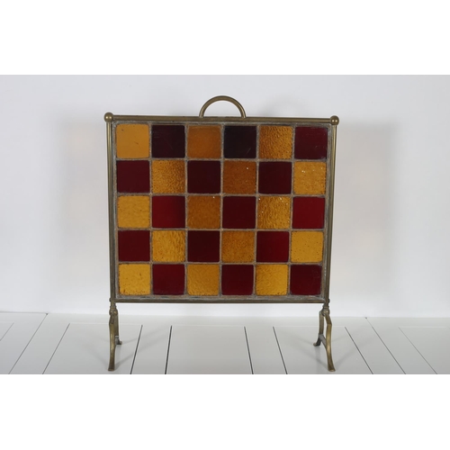 56 - A 19TH CENTURY BRASS LEAD GLASS AND COLOURED GLASS FIRE SCREEN of rectangular outline with glazed pa... 