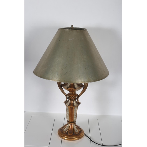 57 - A CONTINENTAL GILT METAL AND BRASS TABLE LAMP the central reeded leaf capped and faceted column issu... 