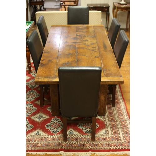 8 - A NINE PIECE DINING ROOM SUITE comprising oak planked top refectory style table together with eight ... 