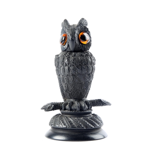 40 - A Victorian bog oak vesta in the form of a long-eared owl, the head with amber glass eyes, lifting t... 