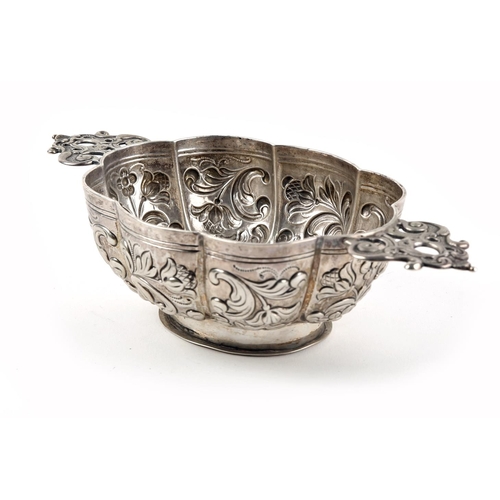 60 - Dutch silver brandy bowl, the oval lobed body repousse decorated with scrolling foliate motifs, and ... 