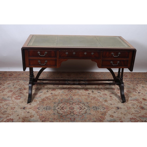19 - A REGENCY DESIGN MAHOGANY DROP LEAF WRITING TABLE the rectangular hinged top with tooled leather ins... 