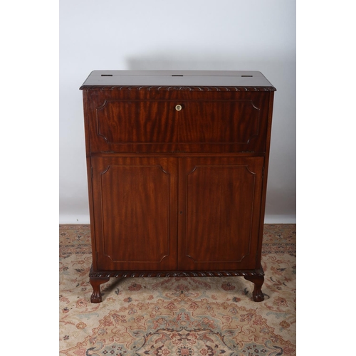 34 - A CHIPPENDALE DESIGN MAHOGANY COCKTAIL CABINET the rectangular hinged top containing a mirrored inte... 