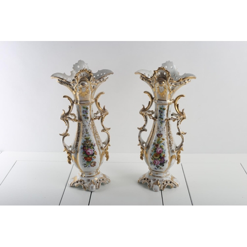 50 - A PAIR OF CONTINENTAL PORCELAIN VASES the white and gilt ground with painted panels depicting flower... 