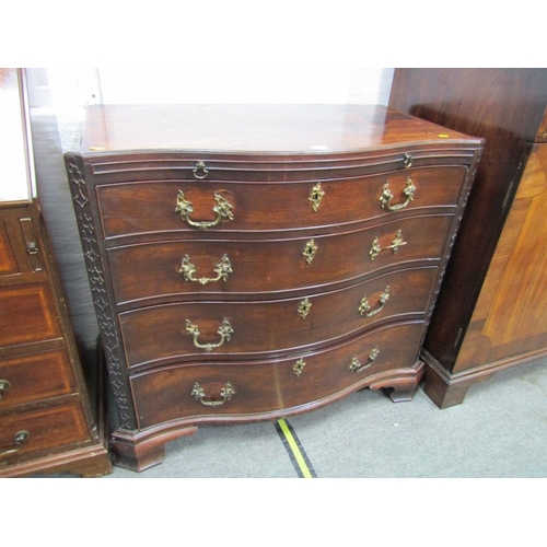 653 - GEORGIAN SERPENTINE FRONTED CHEST OF DRAWERS, blind fretwork canted corners with brushing slide and ... 