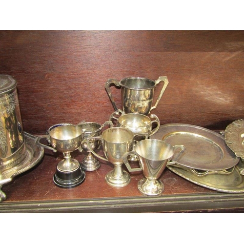 48 - SILVERPLATE, antique engraved biscuitier, oval entree dish, trophy cups & contents of shelf