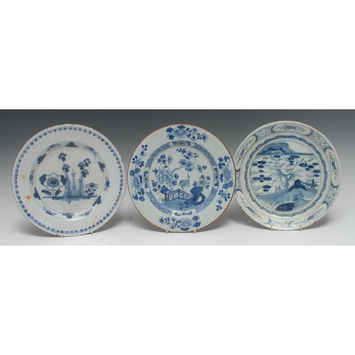 11 - A Delft circular plate, decorated in underglaze blue with stylised flowers, the rim with dots and ar... 