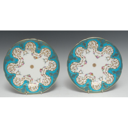 35 - A pair of Minton shaped circular cabinet plates, painted with swags of colourful flowers, turquoise ... 