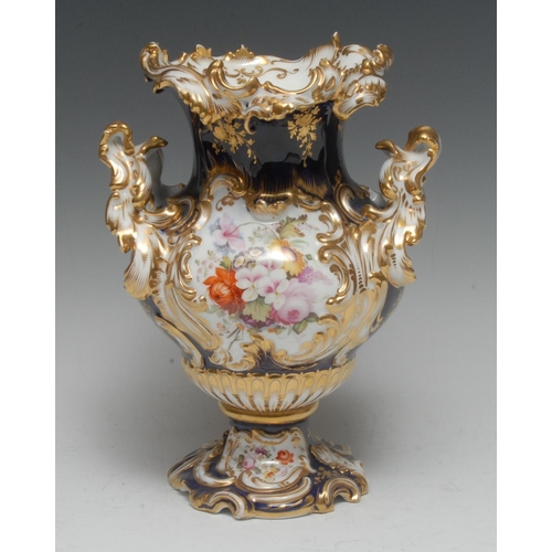 60 - A Coalport Rococo style vase,  painted with colourful summer flowers in relief moulded panel, cobalt... 