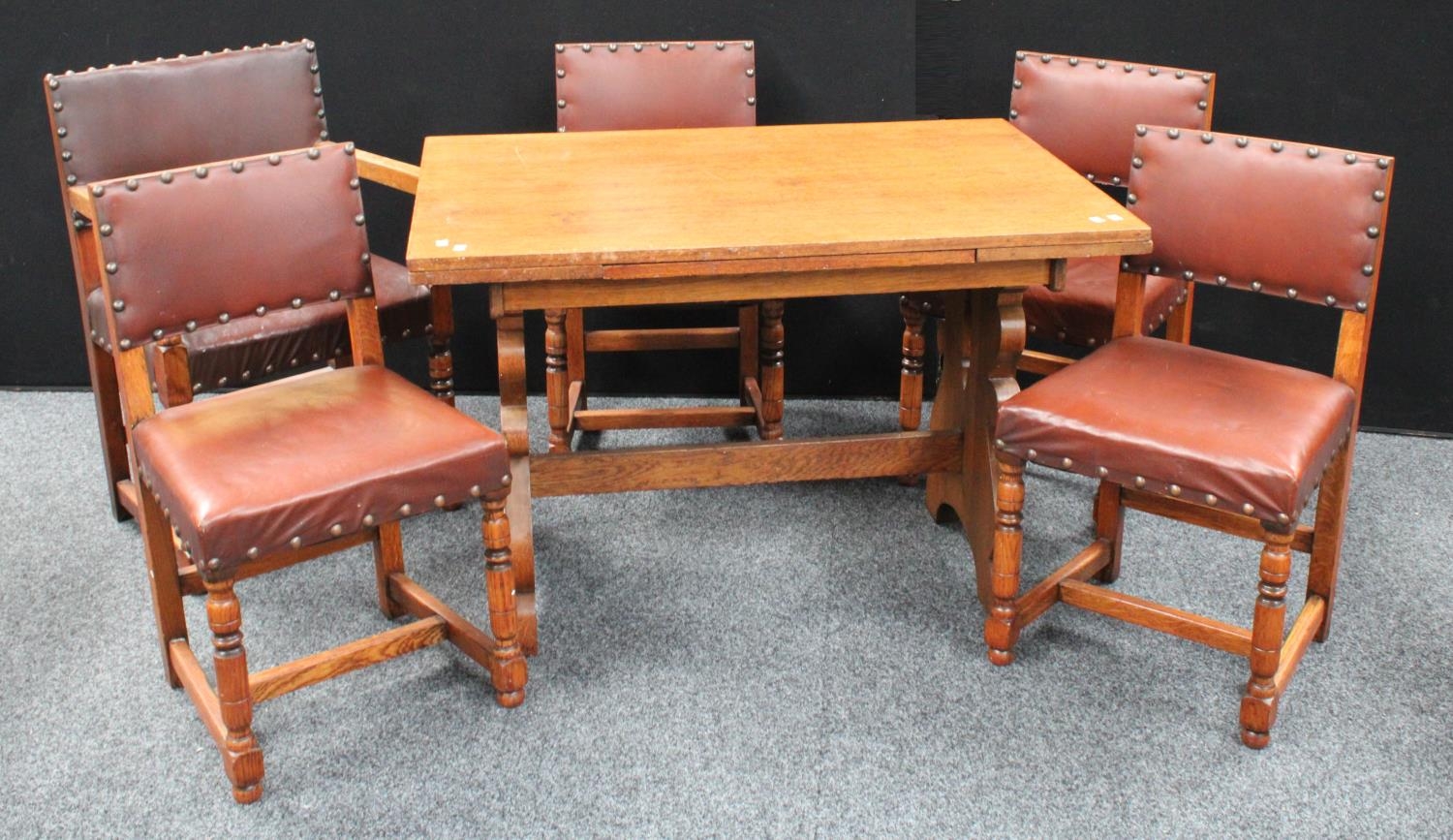 An 'Arts & Crafts' oak drawerleaf dining table, well figured top with...