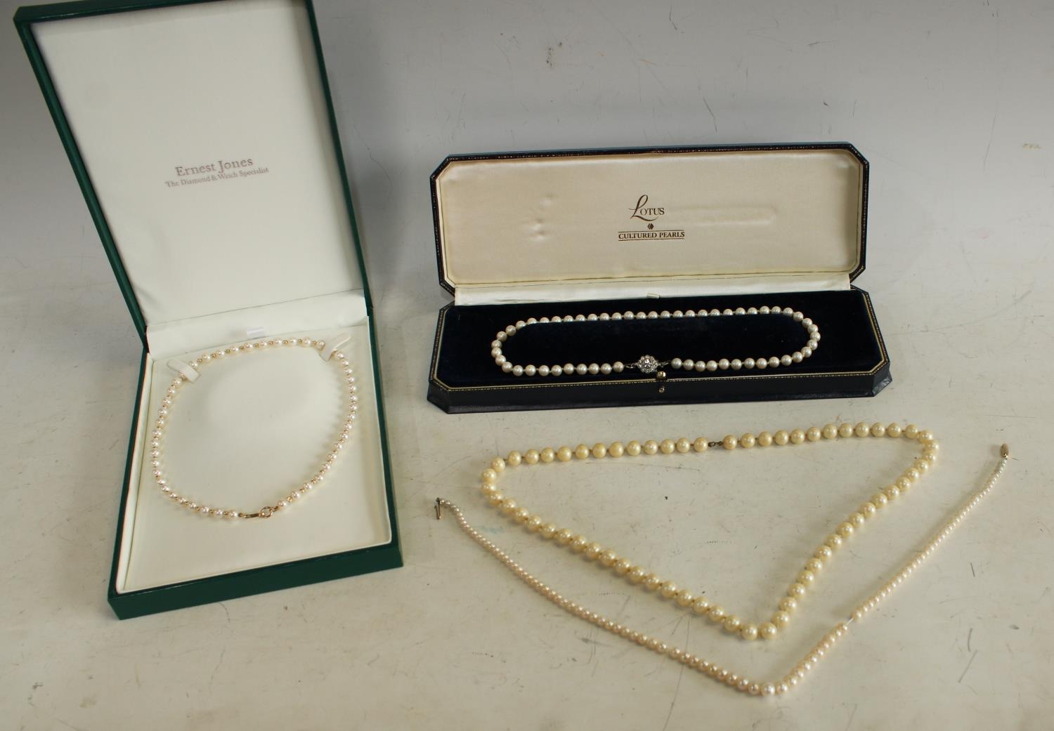 A single strand cultured pearl necklace; a 9ct gold mounted cultured pearl...