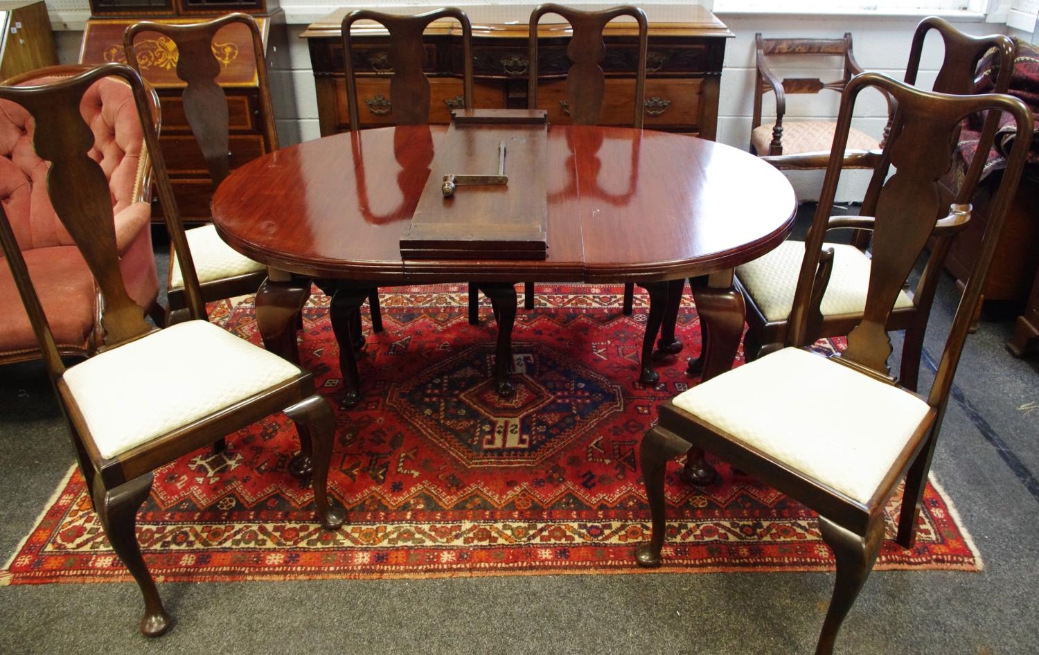 A Selbat Queen Anne style wind out D-end dining table with two leaves...