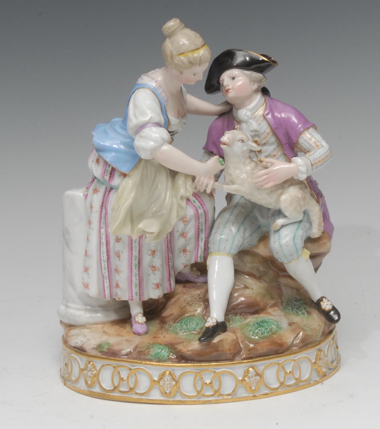 A Meissen figure group, of a gallant and companion, he seated, with a ...