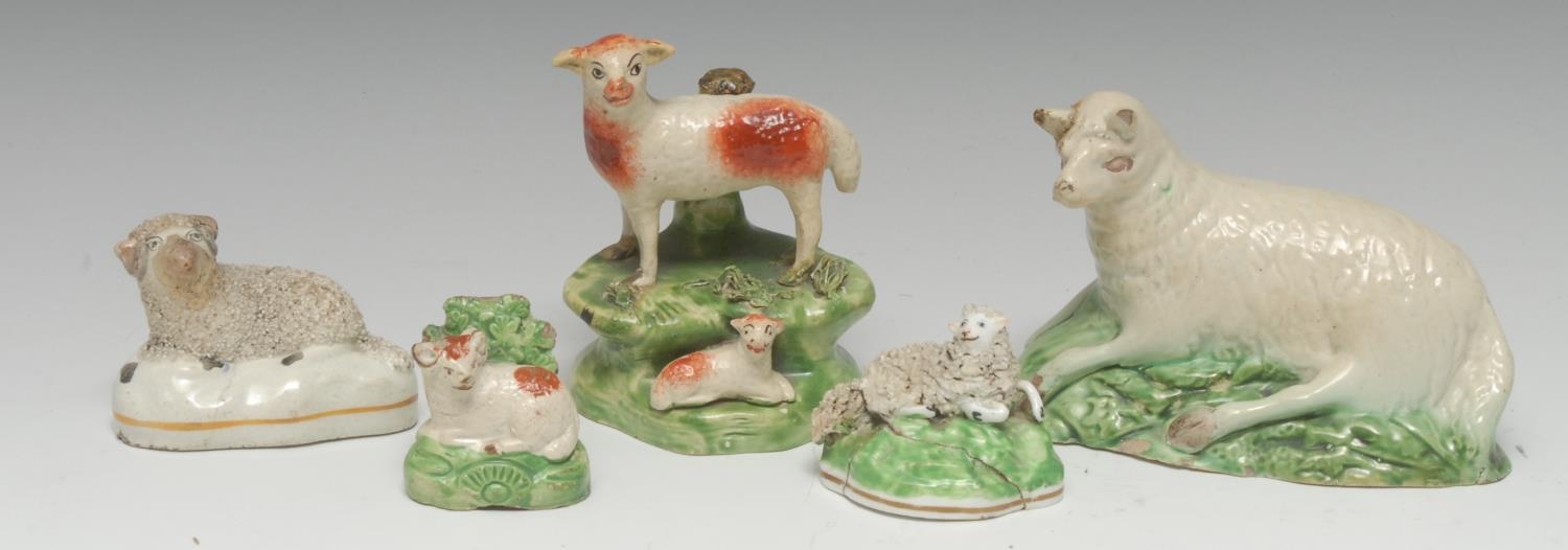 An 18th century Staffordshire creamware recumbent sheep, leaf moulded green...