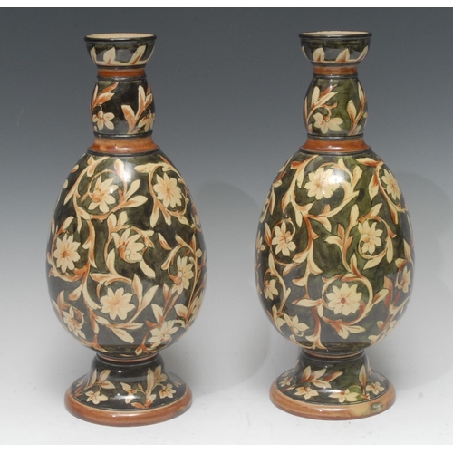 49 - A pair of Doulton Lambeth ovoid vase, painted with scrolling foliage, on an olive ground, 29cm high,... 
