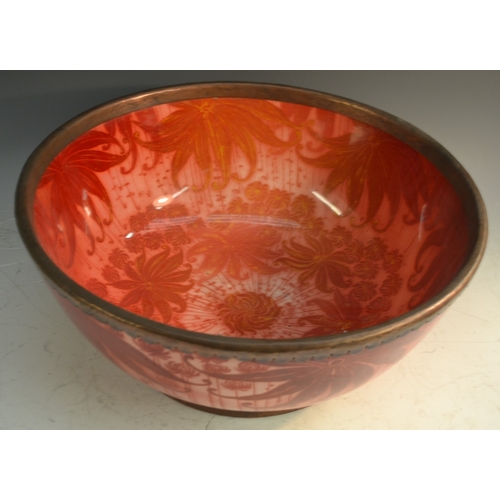 53 - A Bernard Moore red lustre punch bowl, decorated with large leaves on a red ground, metal rim, 40cm ... 