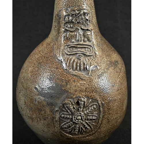 5003 - A 17th century grey/brown salt glazed stoneware bellarmine, bearded mask above floral boss medallion... 