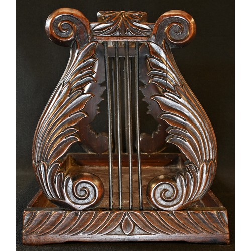 5006 - A 19th century Anglo-Indian hardwood book carrier, lyre-shaped end supports carved with scrolling ac... 