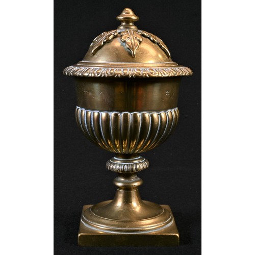 5056 - A 19th century polished bronze half-fluted urn and cover, knop finial with acanthus boss, square bas... 