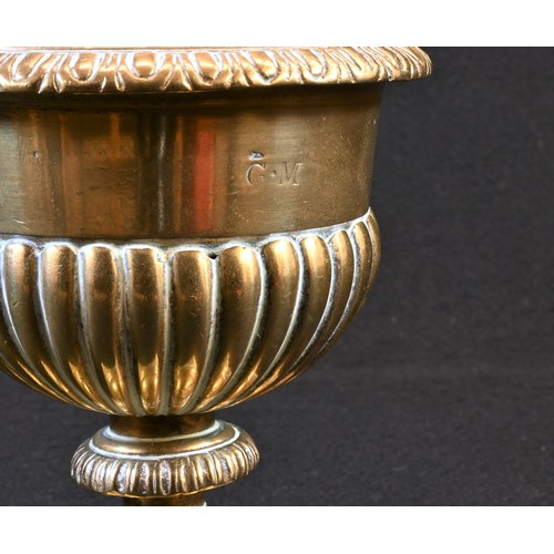5056 - A 19th century polished bronze half-fluted urn and cover, knop finial with acanthus boss, square bas... 