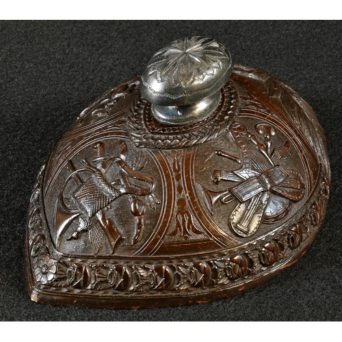 5018 - A 19th century Colonial coconut shell, finely carved with musical trophies, 12.5cm wide