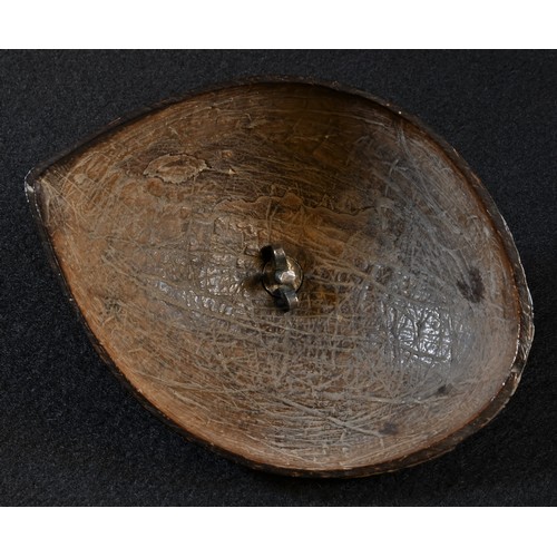 5018 - A 19th century Colonial coconut shell, finely carved with musical trophies, 12.5cm wide