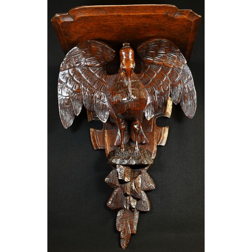 5000 - A 19th century oak wall bracket, carved as a pelican in her piety, shaped plateau, 52cm high, 35cm w... 
