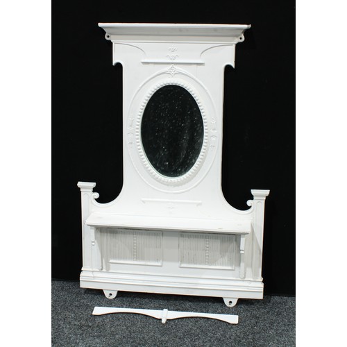 61 - A 'Victorian' cast iron chimney piece, the painted superstructure with an oval mirror plate above a ... 