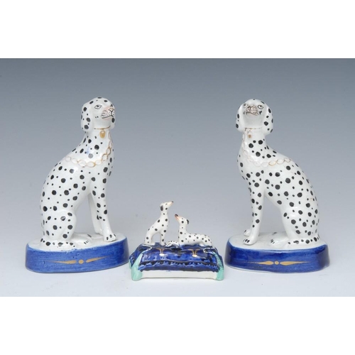 20A - A pair of Staffordshire dalmations, seated to the the left and right, blue oval bases, 14cm high, c.... 