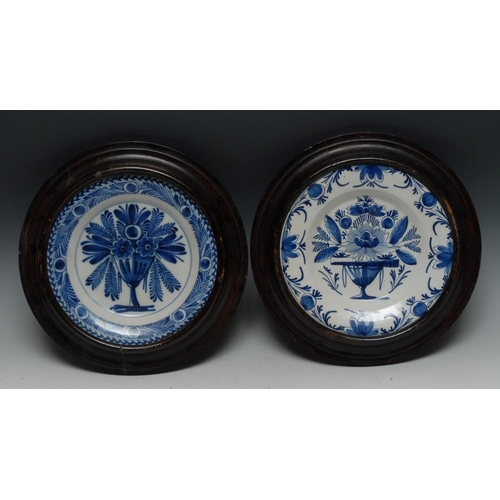 3 - An 18th century Dutch Delft circular plate, the centre painted in typical cobalt blue with a floweri... 