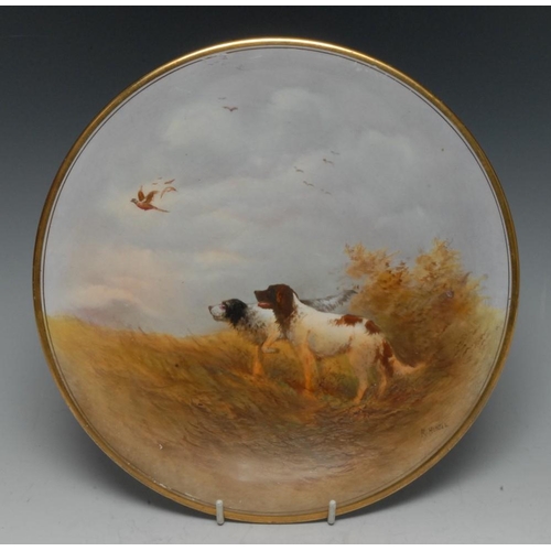 39 - A Crown Devon circular plate, painted by R. Hinton, signed, with gun dogs in the open field and Phea... 