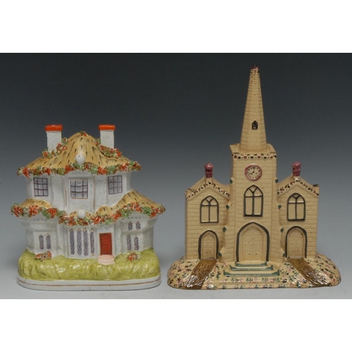 7 - A Staffordshire model of a church, with central spire, in buff, picked out in brown and puce, 24cm h... 