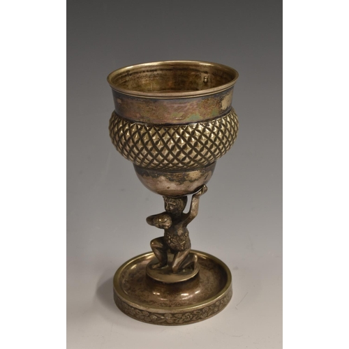 51 - A Continental silver goblet, the bowl supported by a scantily clad grape picker, dished circular bas... 