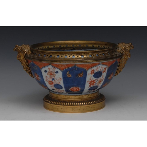 28 - An ormolu mounted Imari circular bowl, typically painted with flowers and sprigs within ogee arched ... 