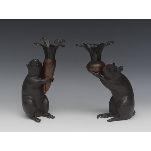 42 - Japanese School, a pair of brown and dark patinated bronze candlesticks, each cast as a rat holding ... 