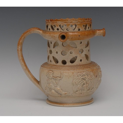 27 - A 19th century brown salt glazed stoneware puzzle jug, pierced with hearts and geometric motifs, spr... 