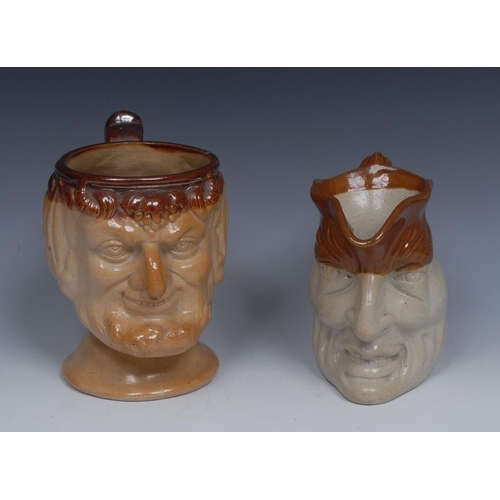 37 - A 19th century salt glazed stoneware Bacchus mug, fruiting vine hair, leafy scroll handle, 18cm high... 